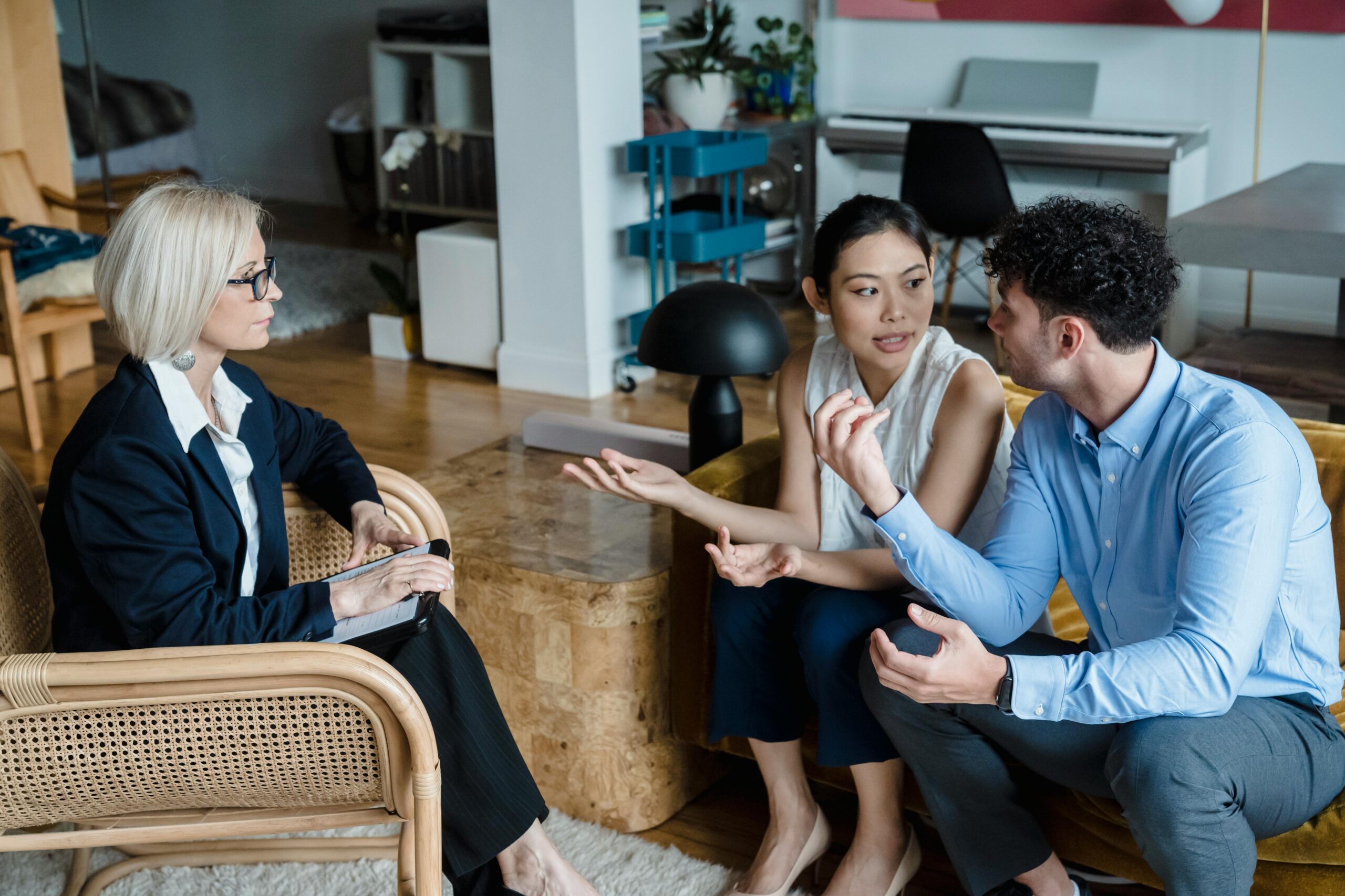 Image of couple looking at each other and talking in therapist office.