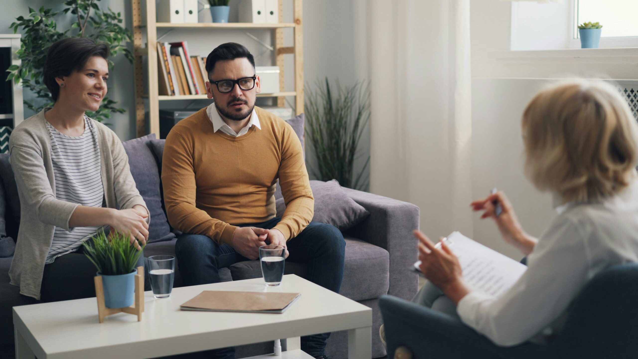 Image of couple on couch in therapist office doing couples therapy.