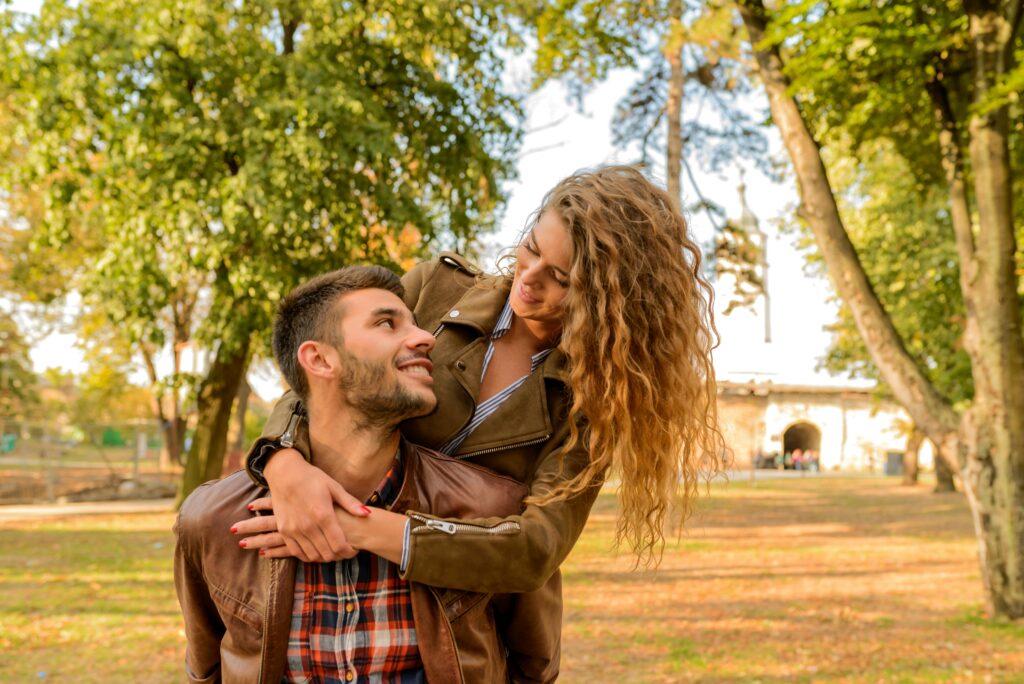 Image of woman hugging man from behind.