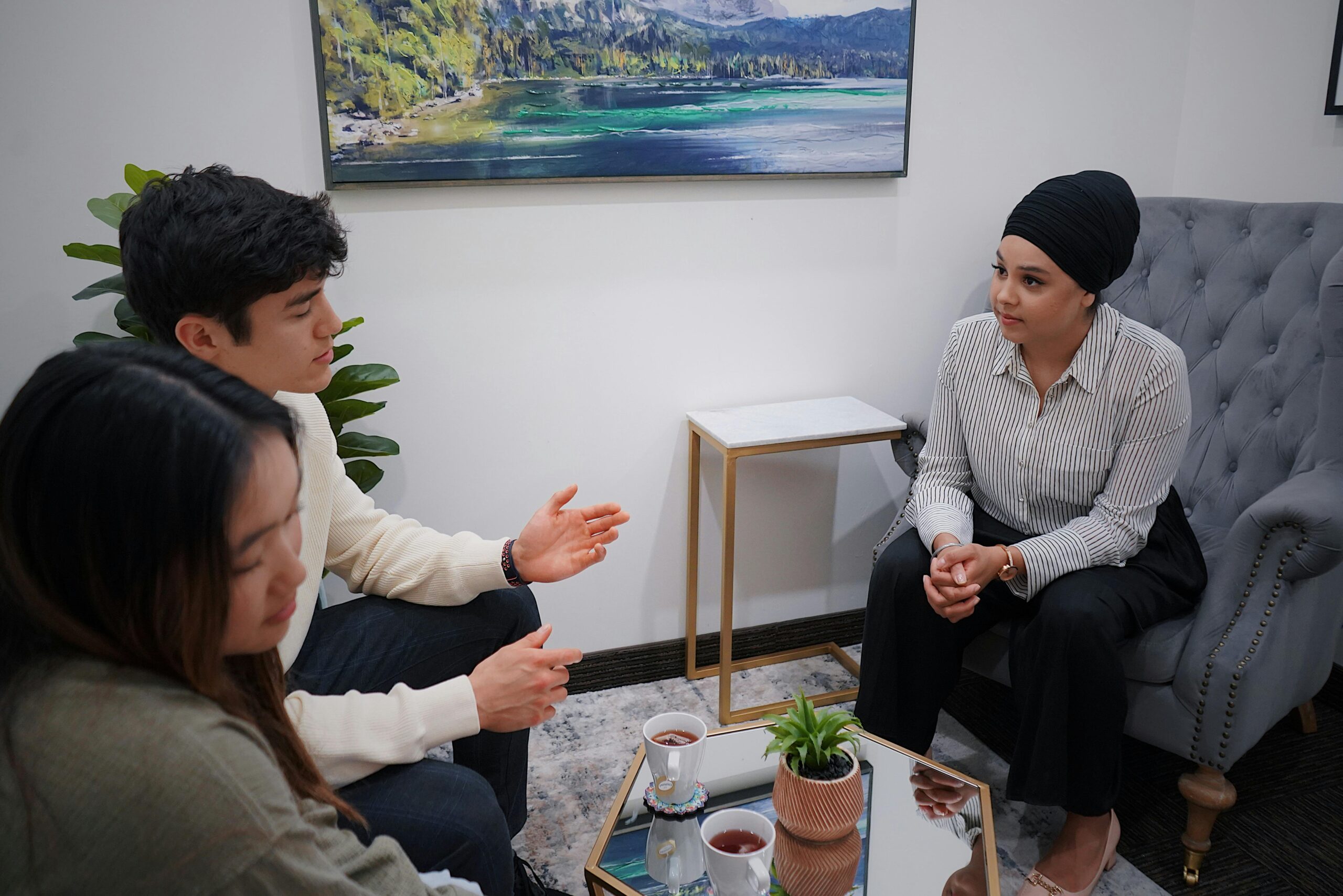 Image of couple in couples therapy with therapist in office.