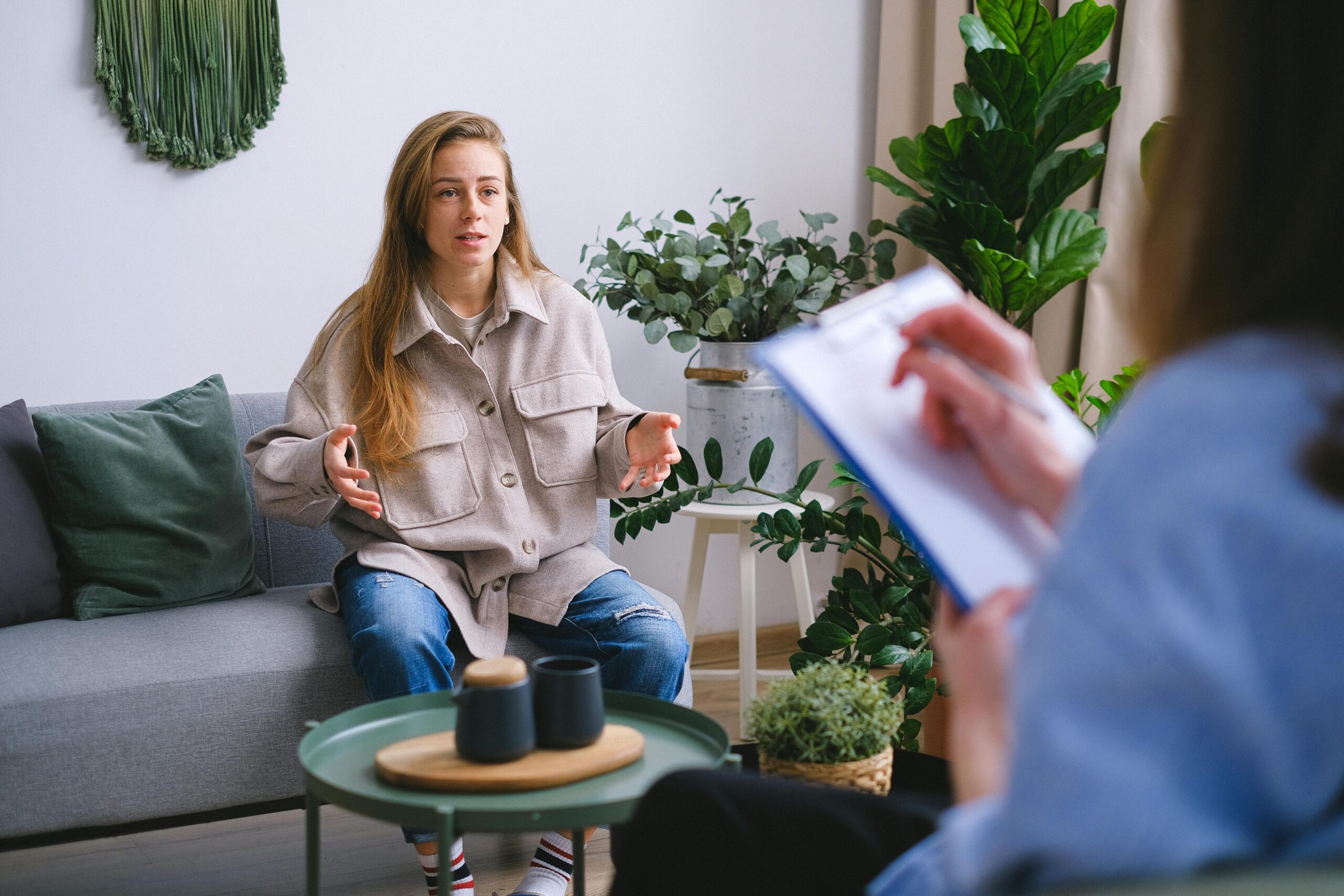Image of patient holding hands up to make a statement with therapist.