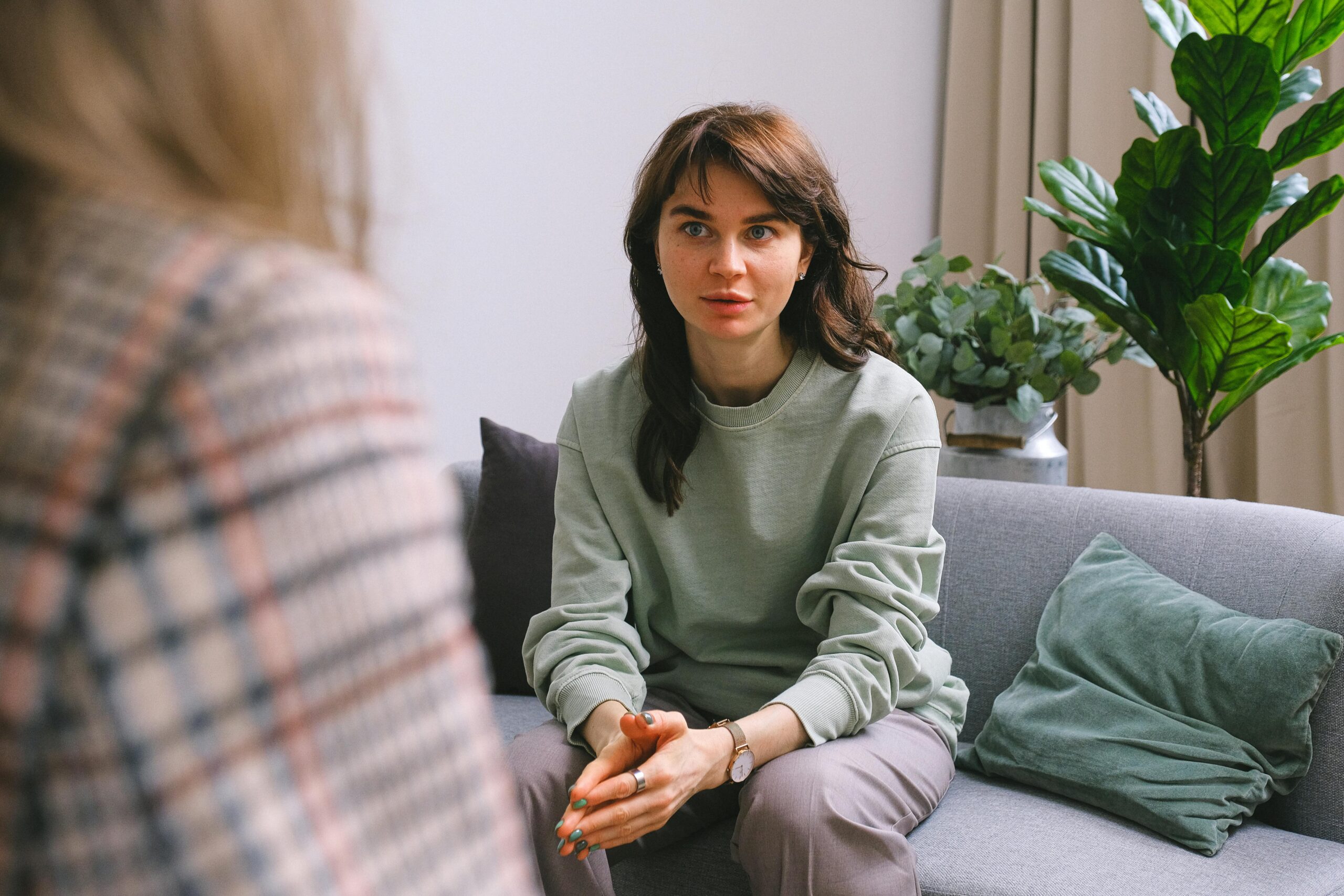 Image of patient and therapist talking in therapy office.