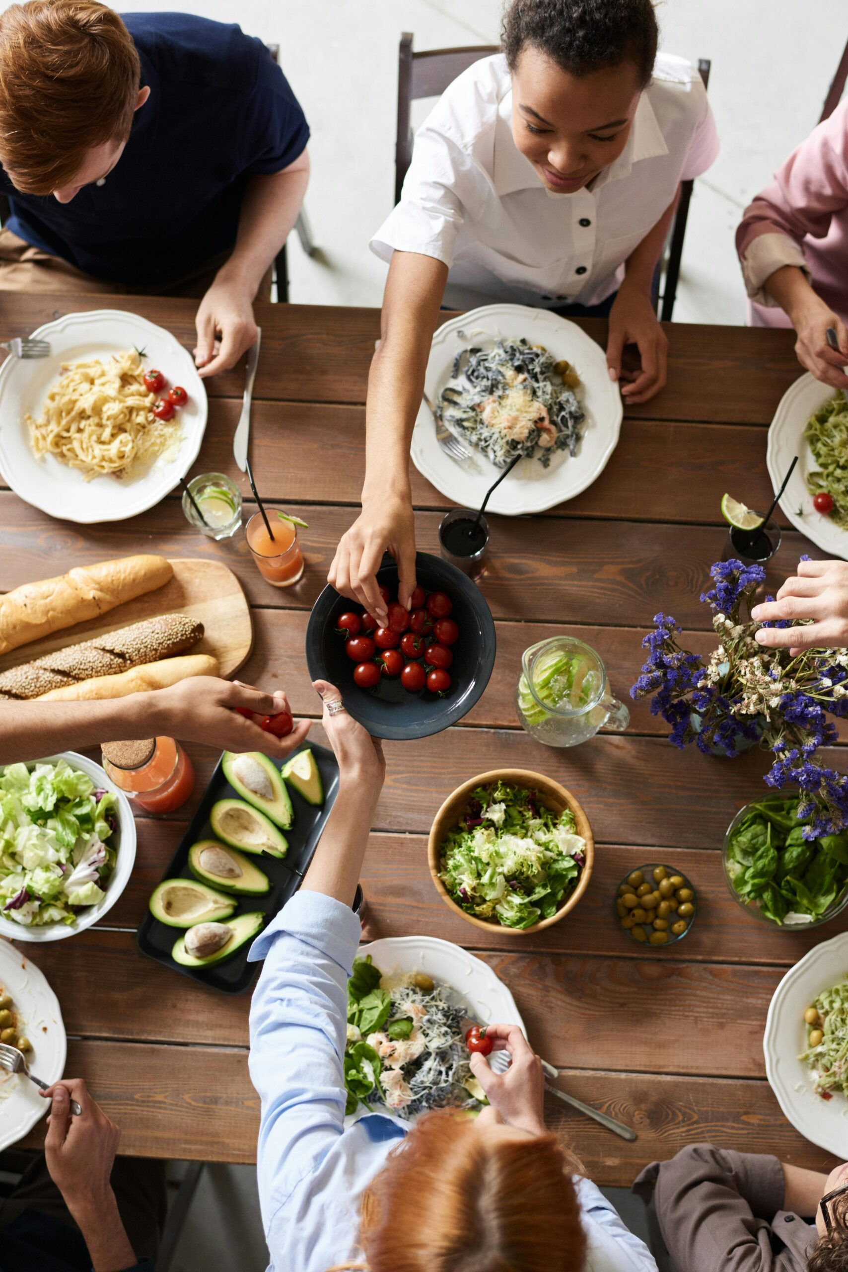Family sitting at dinner table sharing meal to depict family therapy service.