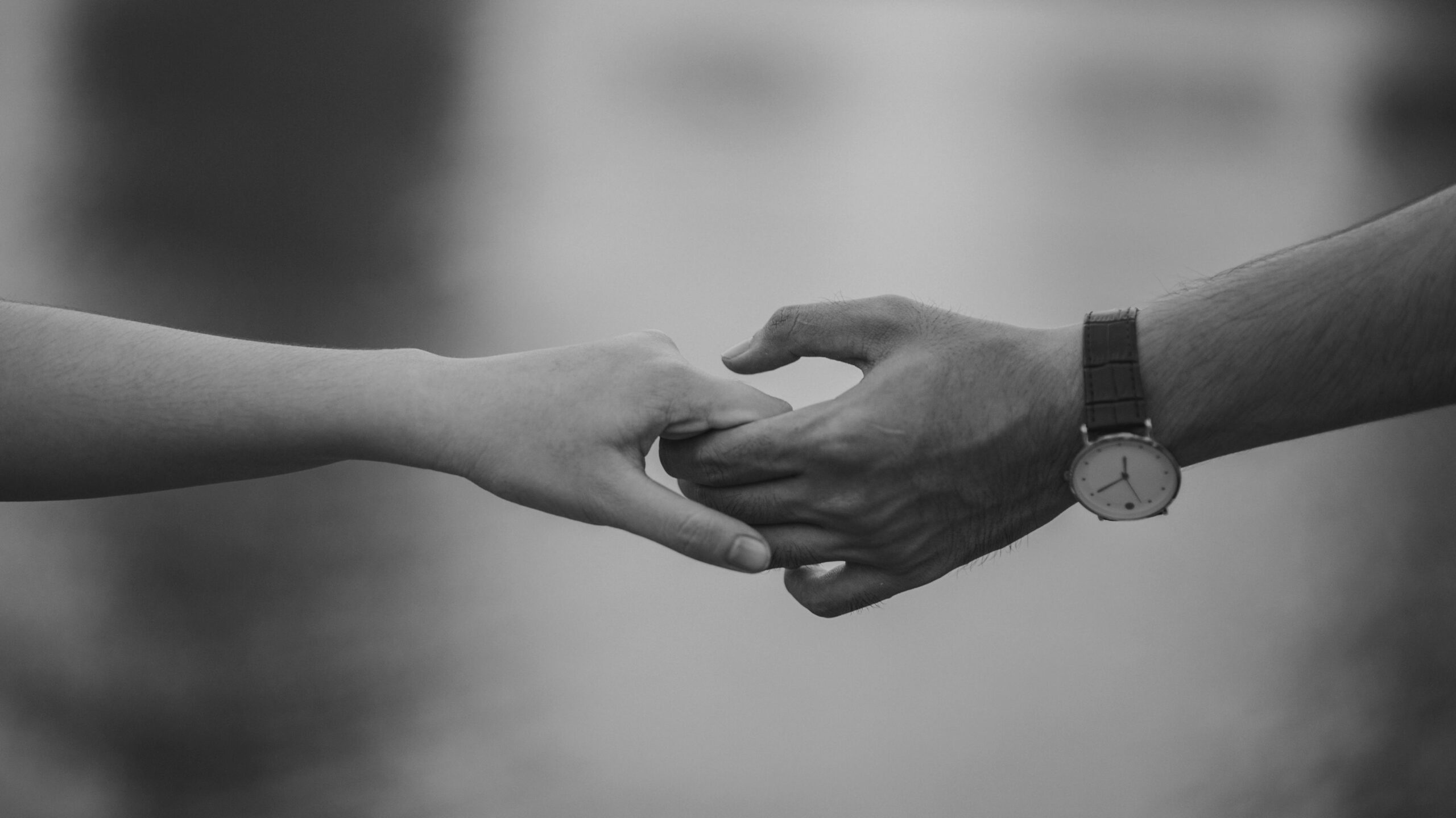 Image of two people holding hands to depict couples therapy service.