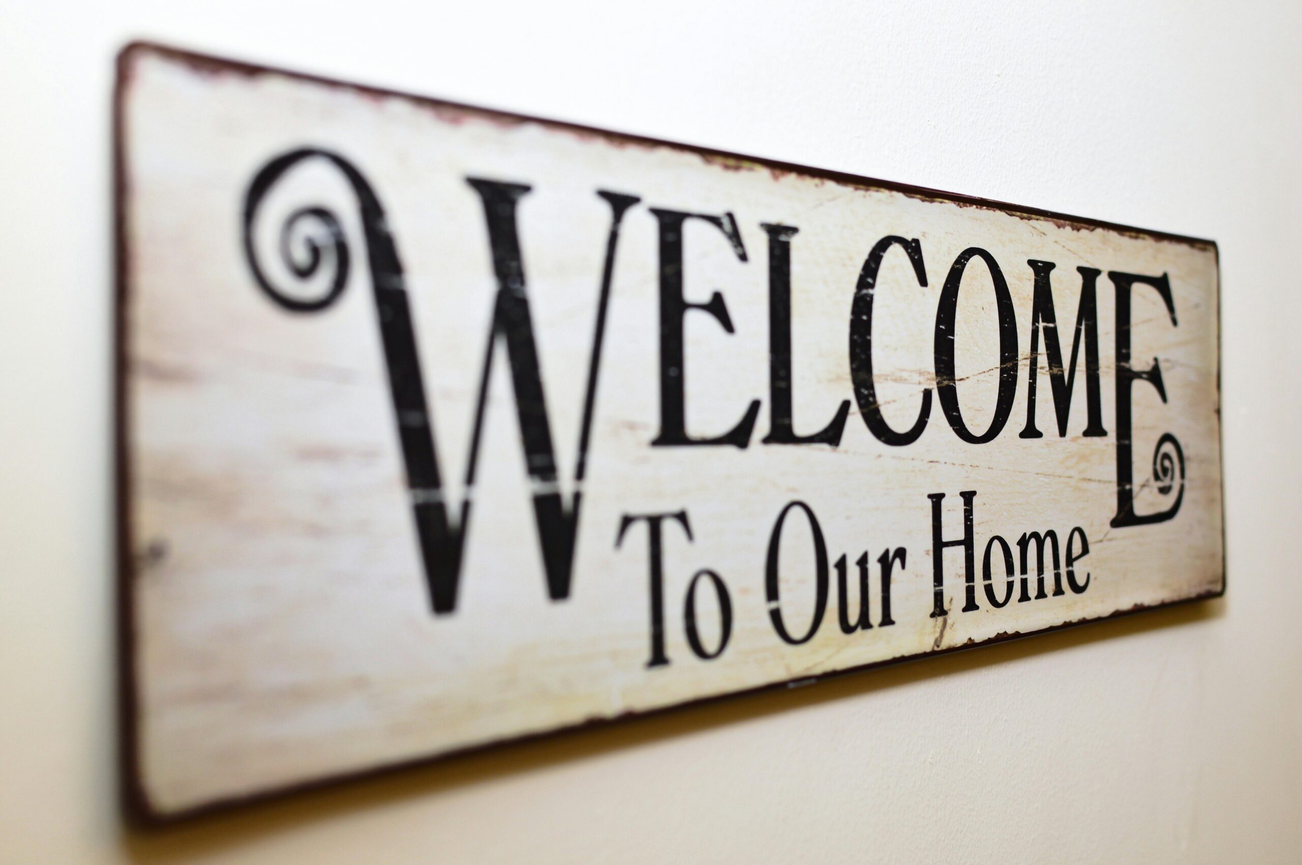 Image of sign that states, "Welcome to our home," as backdrop image to the words, "Family Therapy."