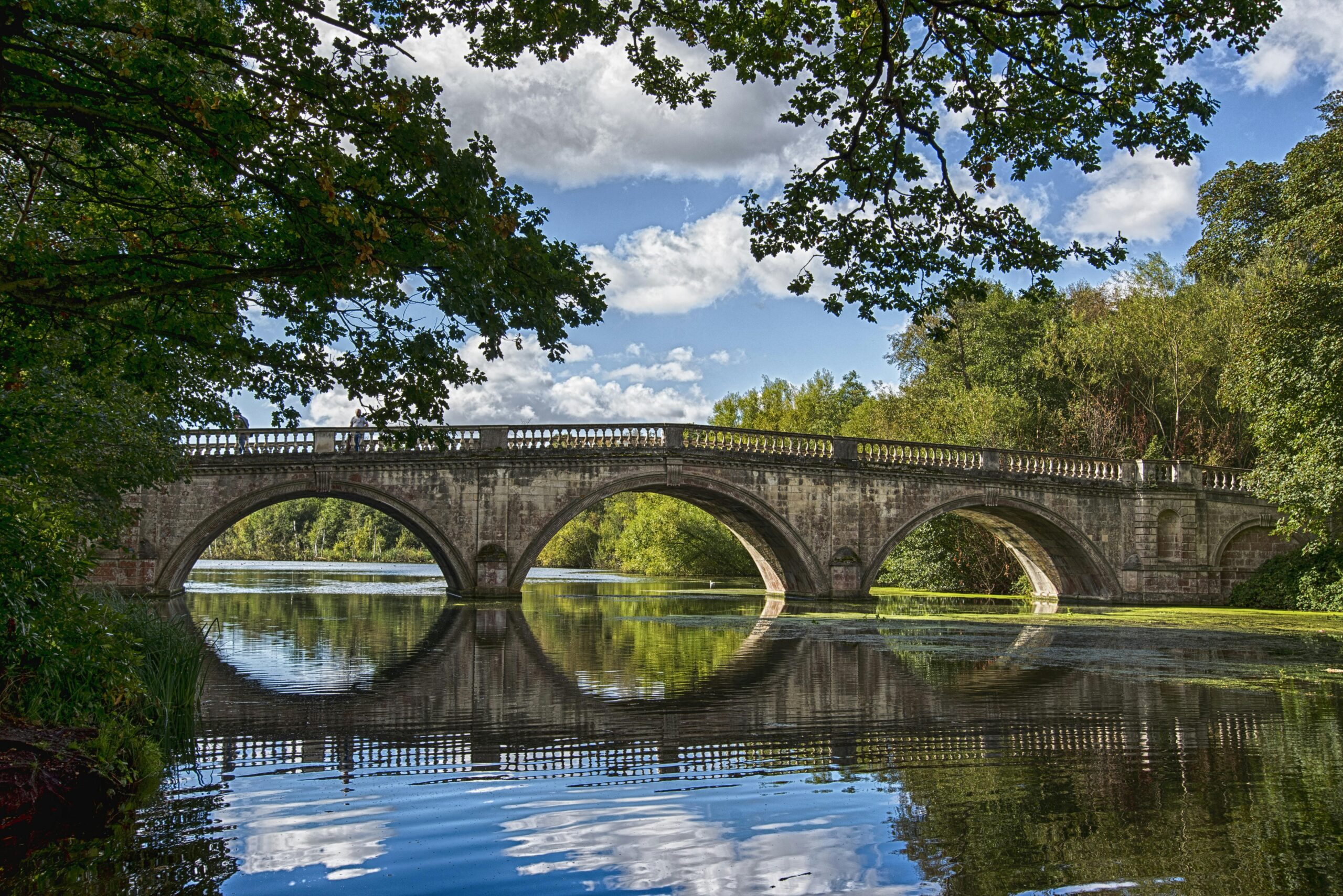 Image of bridge with reflection in the water.